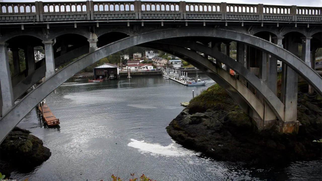 The Blue Wing Mojiko drawbridge raised open to allow a vessel through, with the harbor behind